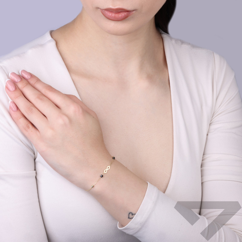 Bransoletka złota infinity z czarnymi kulkami fasetowanymi złoto 375